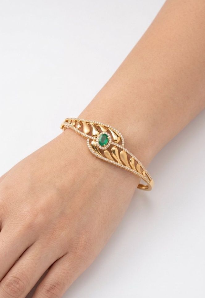 AI Studio render: a gold bangle set with an emerald, worn on a wrist
