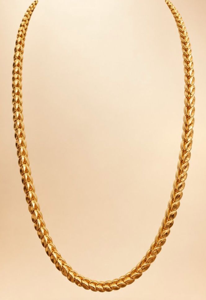 AI Studio render: a cross-leaf gold chain floating against a warm gradient