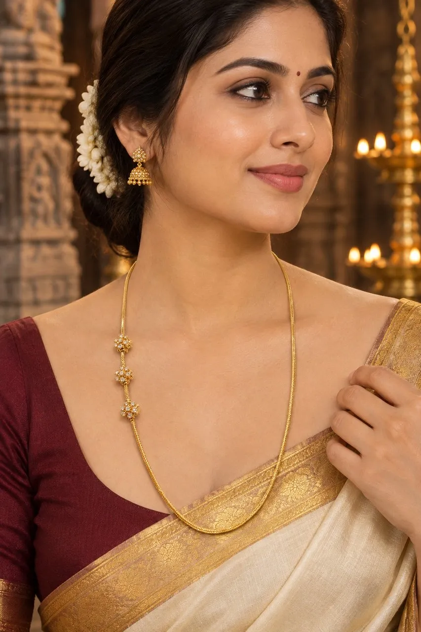 AI Studio result: the chain worn by a model in a silk saree against a temple backdrop