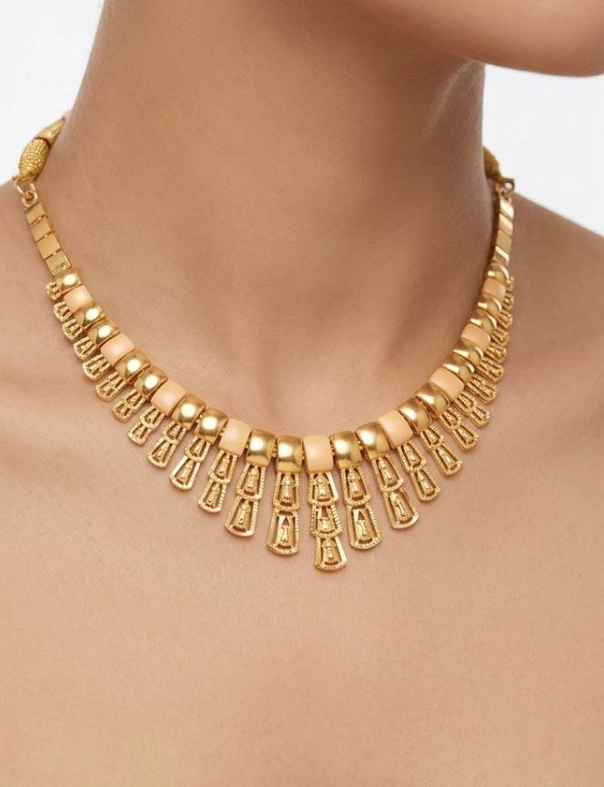AI Studio render: a gold fringe necklace with peach beads, worn at the neck