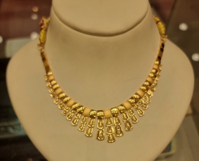 The phone photo it came from: the same necklace on a display bust