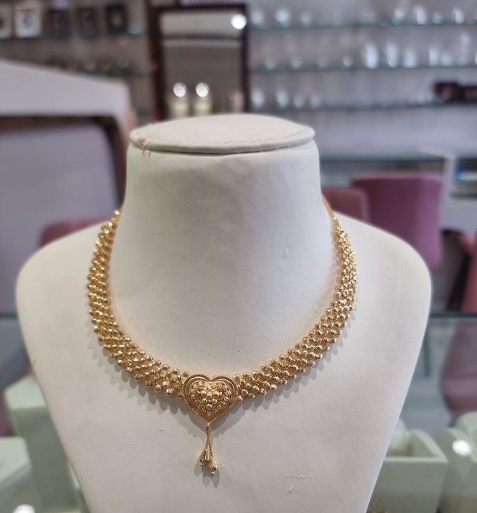 The phone photo it came from: the same necklace on a display bust